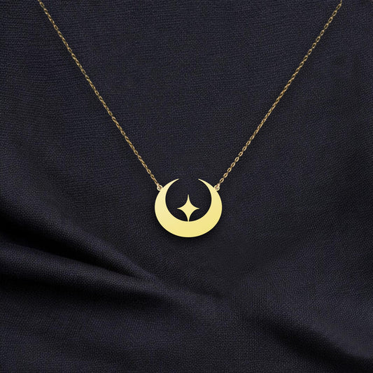 May include: Gold crescent moon necklace with a star cutout. The delicate gold chain and pendant feature a simple, modern design. This celestial-themed necklace is perfect for adding a touch of elegance to any outfit. The pendant is a smooth, polished gold with a subtle shine.